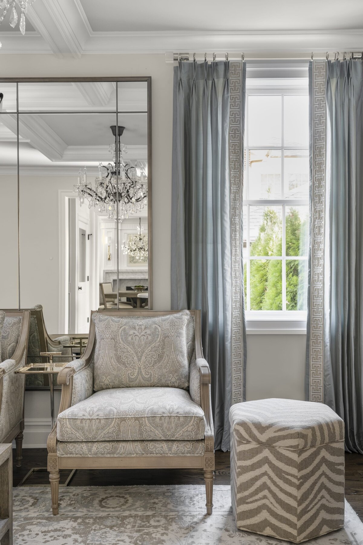 candra lynn interiors ocean port project living room with wall mirror and sitting chair