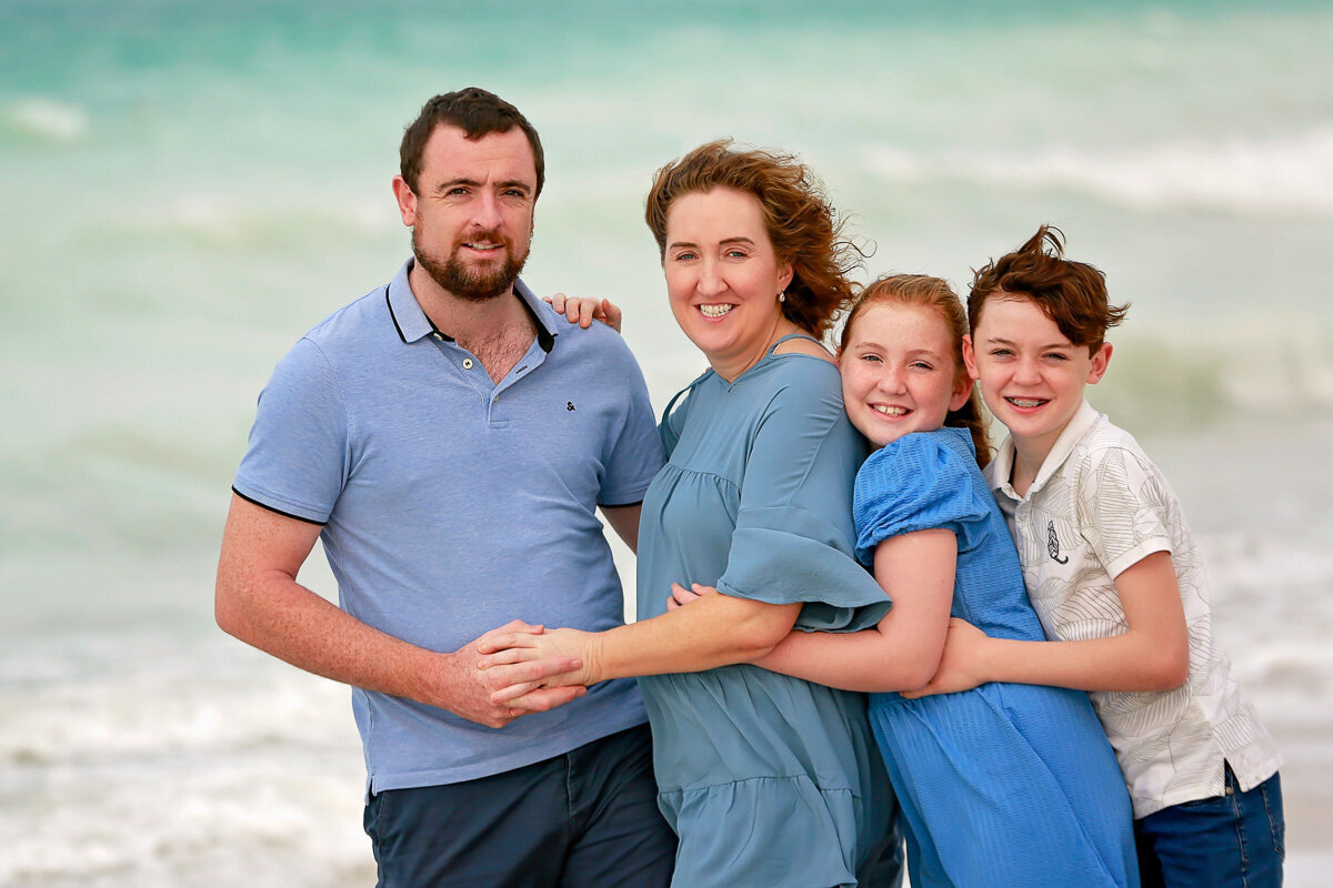 family-hugging-by-the-beach