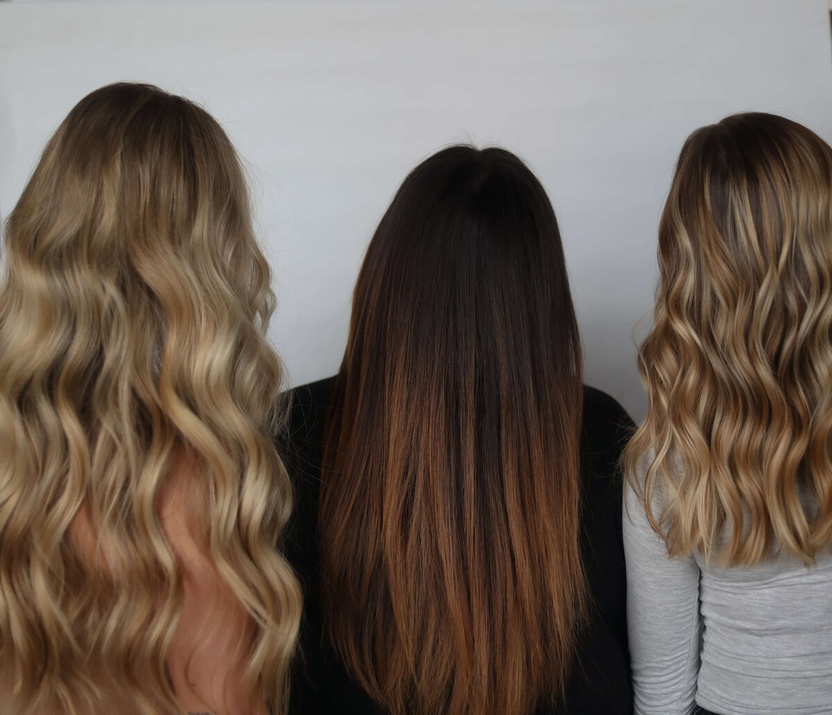 three women showing haircuts in cedar rapids salon