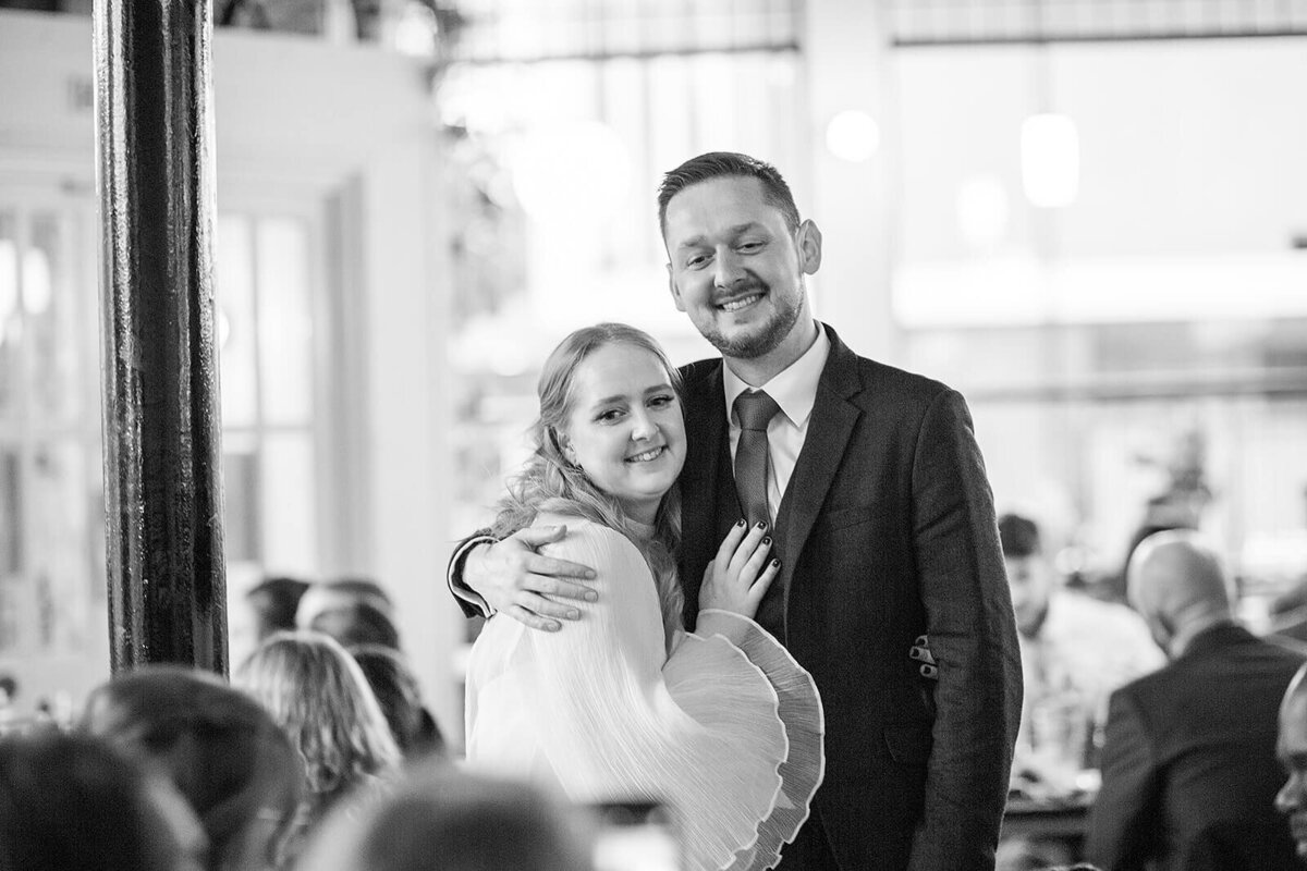 Bride and brother hugging at wedding reception .  At The Coin Laundry London