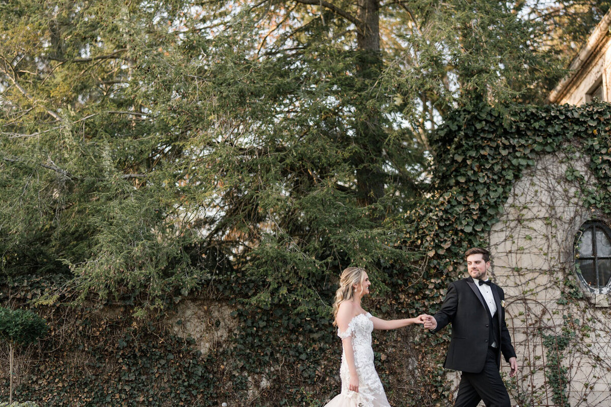 Bride and groom in front of ivy colored wedding venue, taken by Cincinnati Wedding Photographer, Courtney Rudicel
