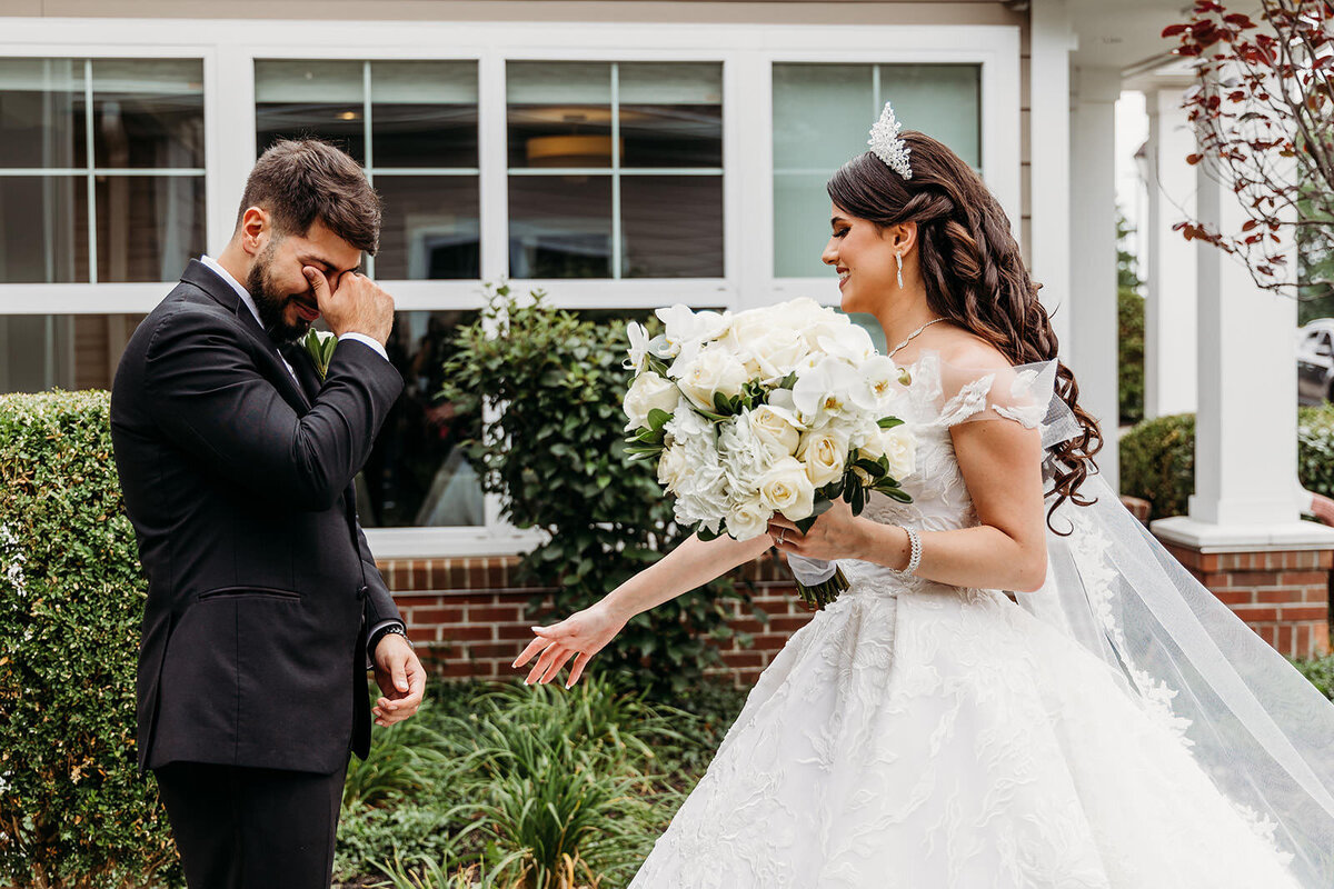 Groom wipes away tears after seeing his stunning bride during 'first look'