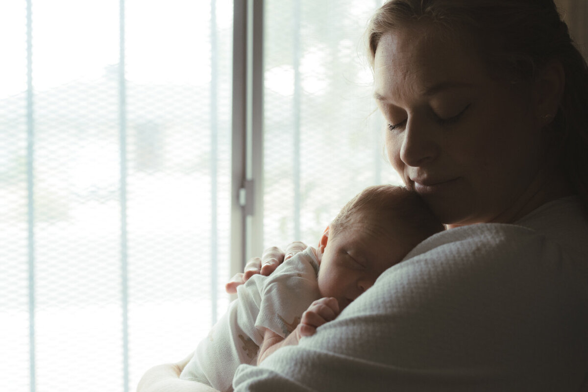 mother holding newborn baby 