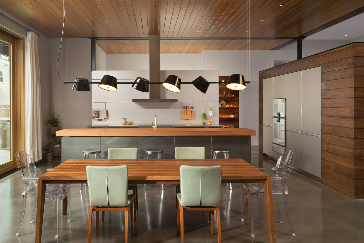 kitchen and dining room with organic elements with green accent chairs