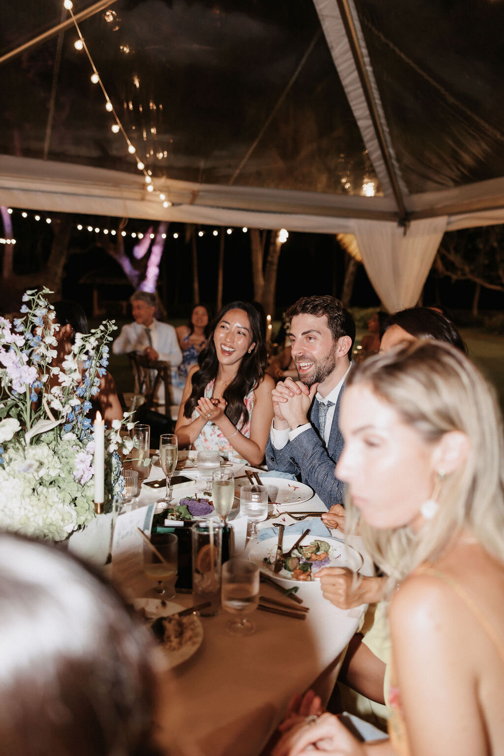 wedding guest candid photo under clear tent at lanikuhonua