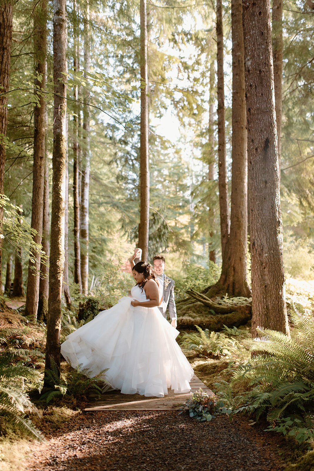 Ashley twriling in a pricess dress with her husband in the  Olympic National forest.