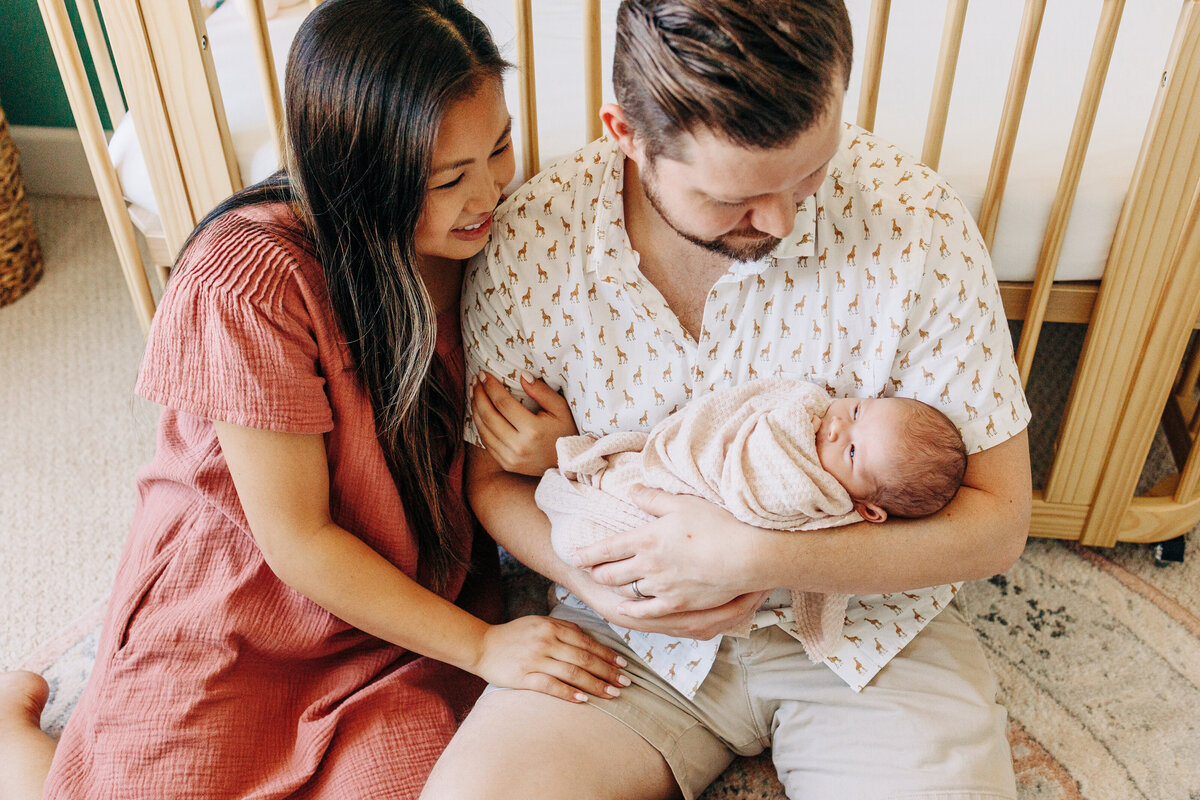 couple holding their baby taken by a houston newborn photographer