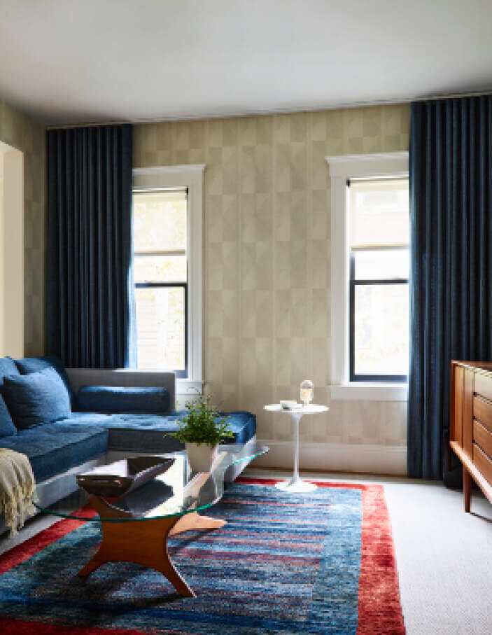 Family room interior design ideas featuring Pierre Frey wallpaper, a Ligne Roset sectional, and mid-century modern vintage pieces for a timeless, curated look.
