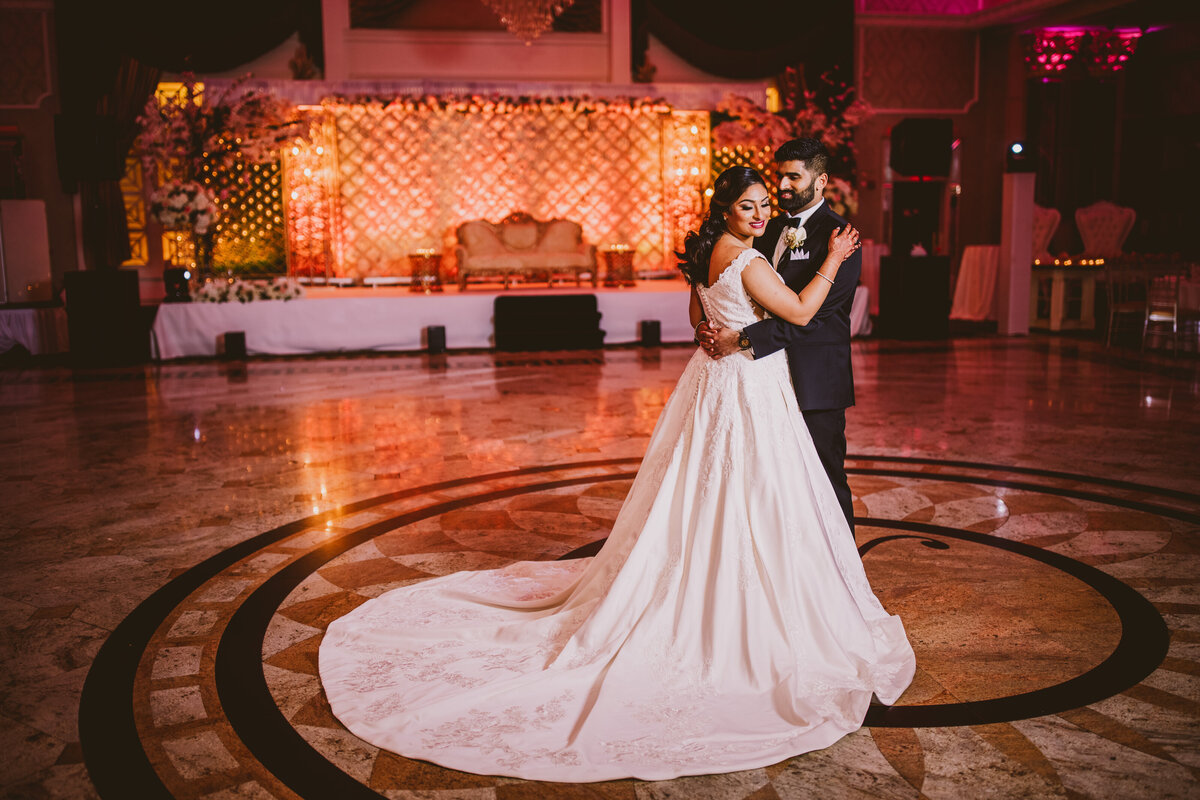 An indian christian bride and groom share a moment inside the banquet hall at the Venetian in NJ on their wedding day