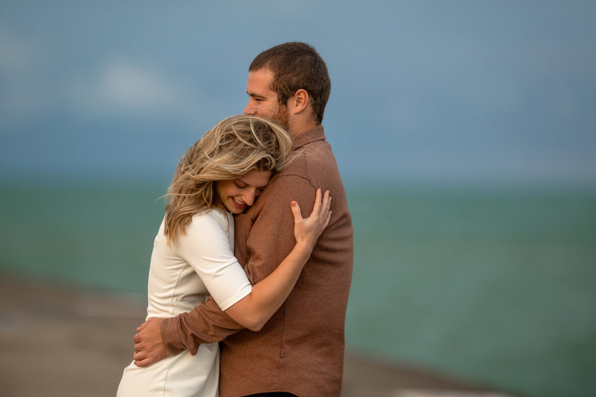 stormy sky and wind day during  engagement pictures at North Ave beach