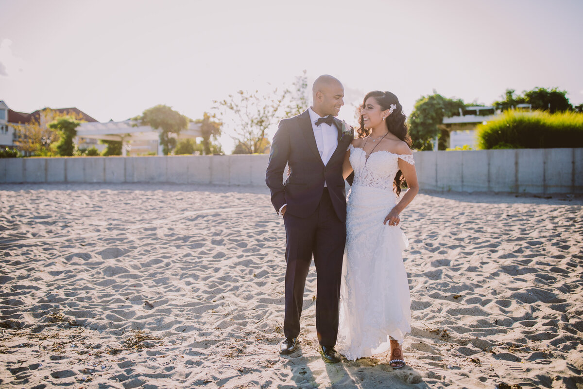 indian christian bride and groom walking on the beach after their wedding hindu ceremony at the greentree country club