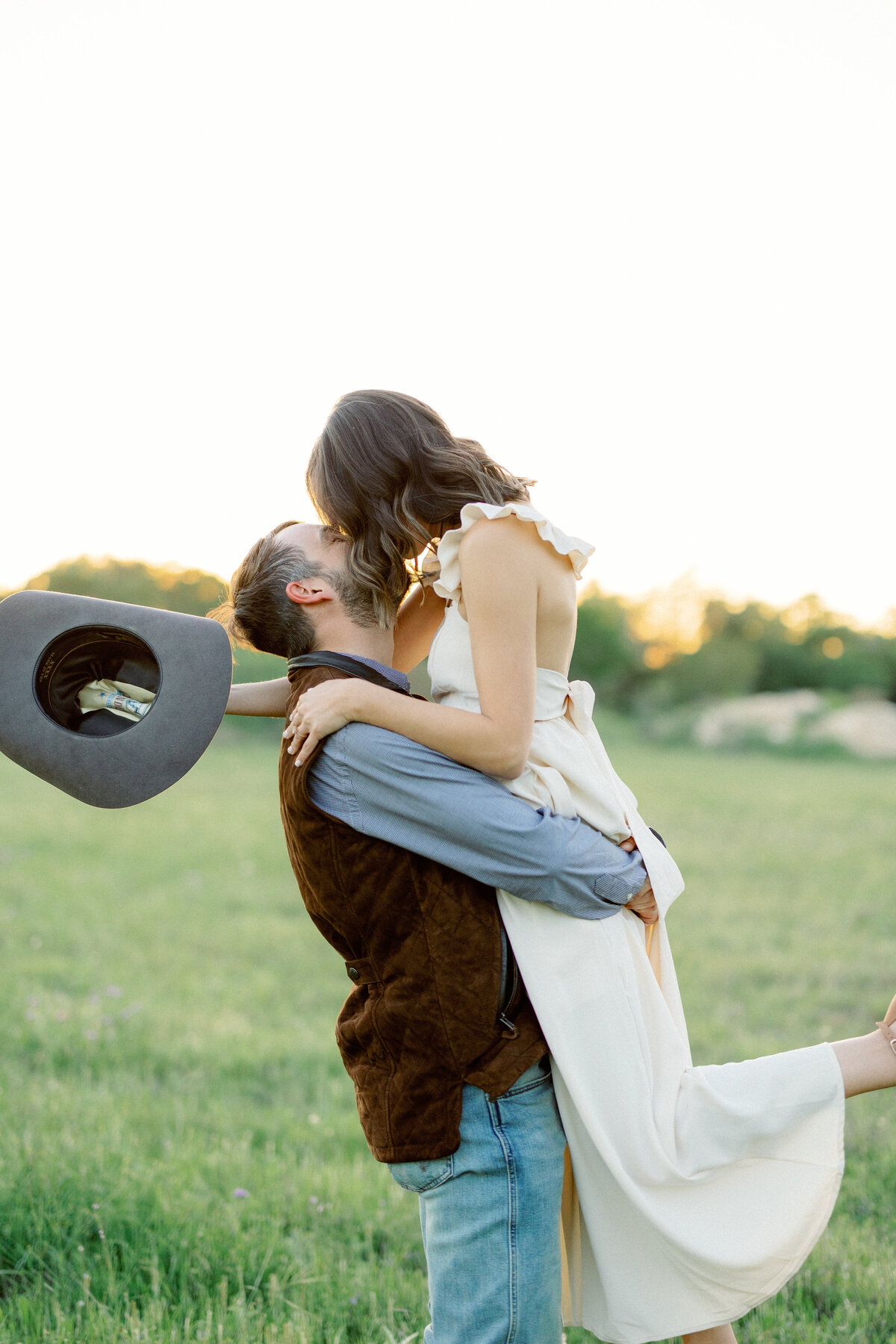 two people embrace and man lifts woman