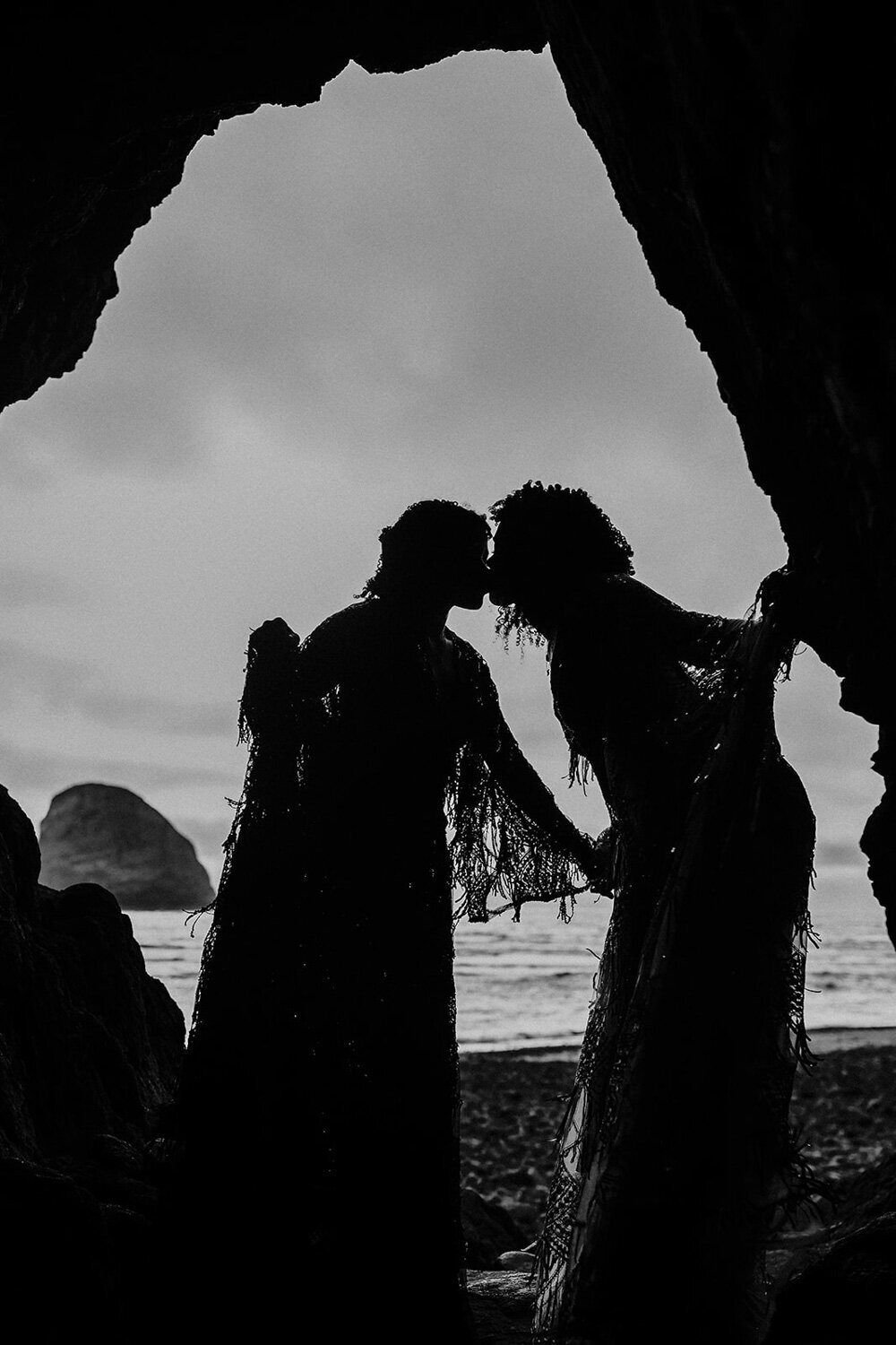 Couple kissing under a cave beside the sea