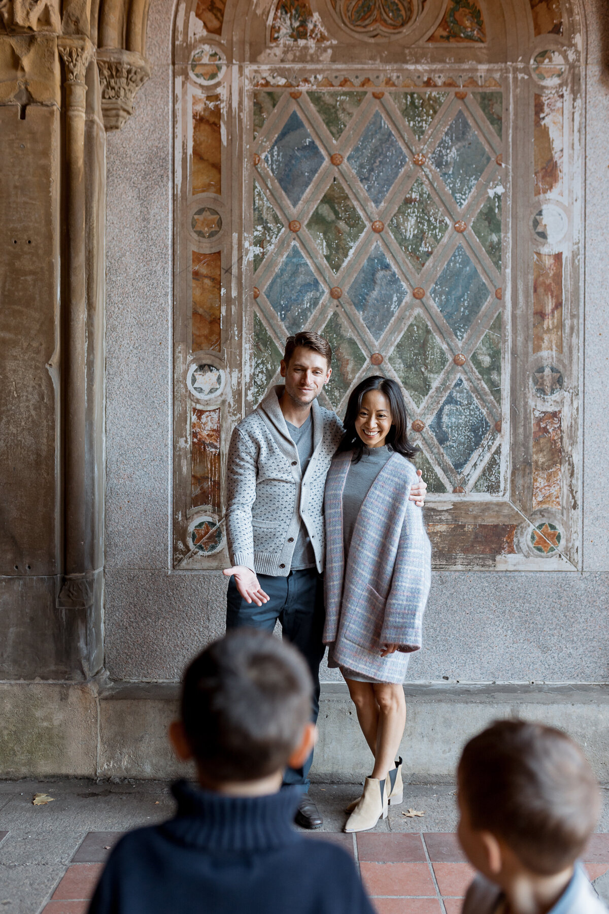 Family Photography, husband and wife embrace outside, their boys look on