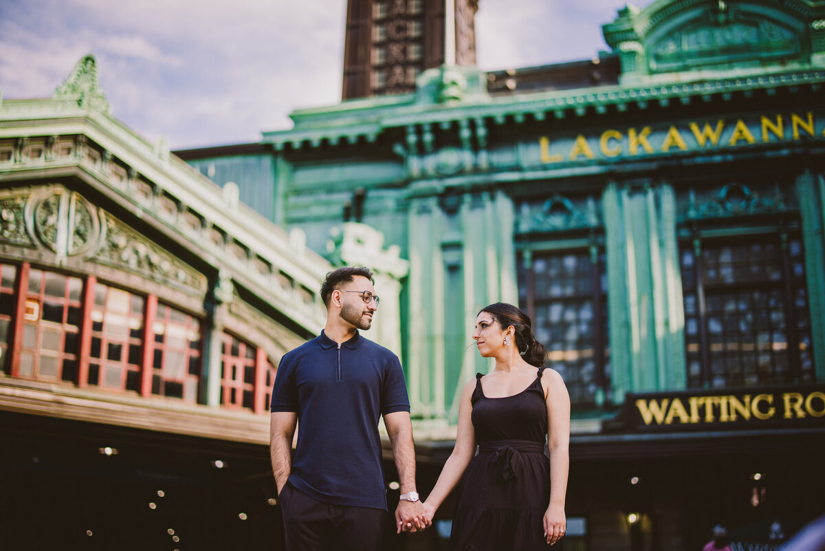 A couple looking at each other in front of the lackawanna hoboken nj terminal station