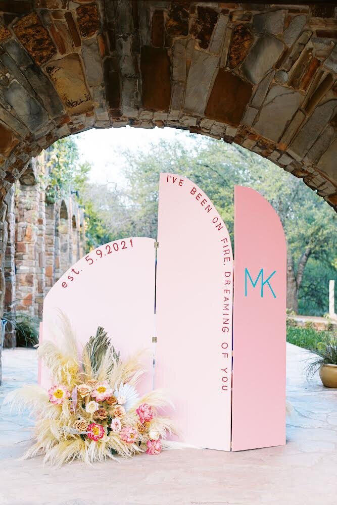 Pink arches wedding day backdrop design