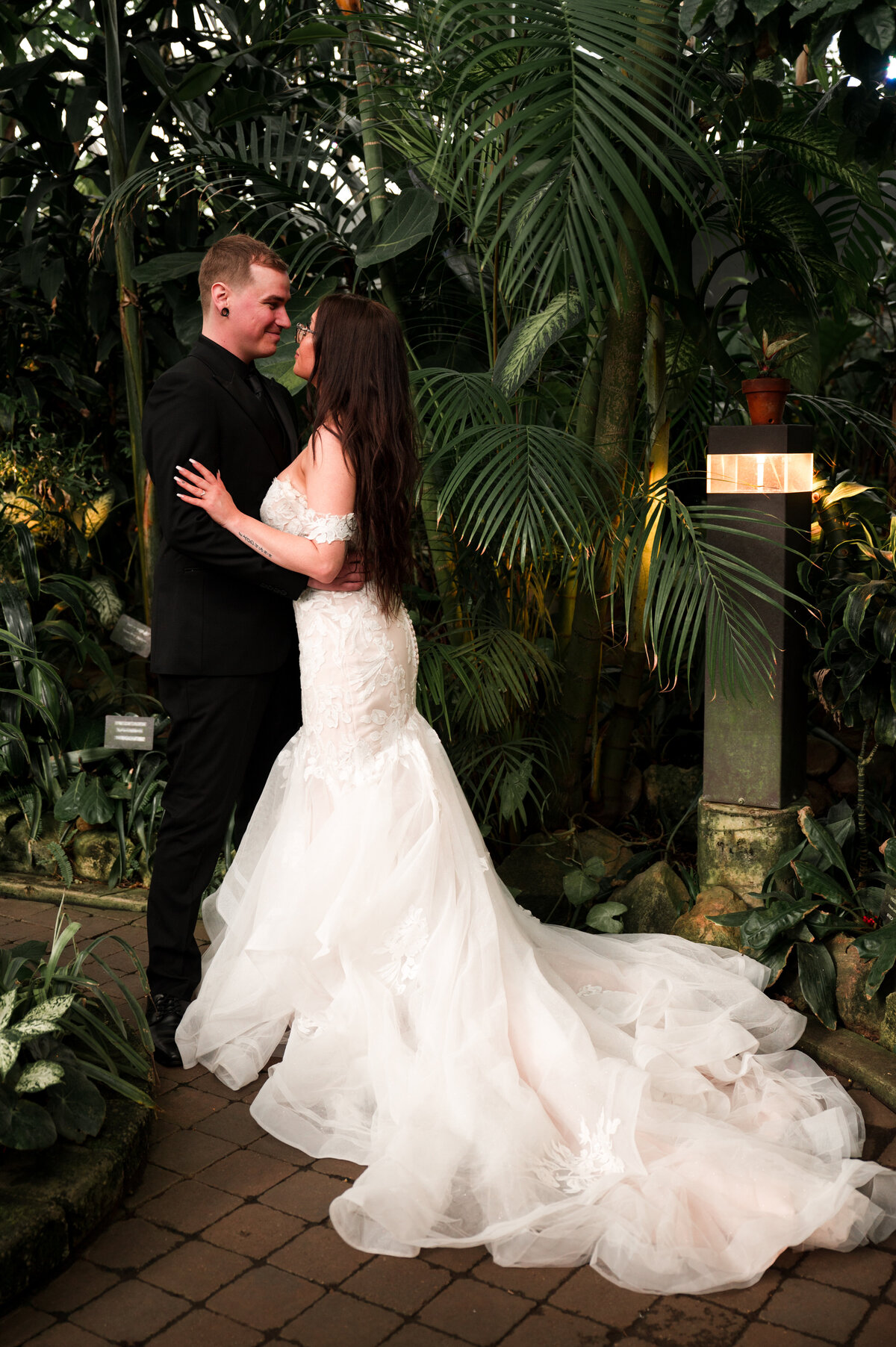 bride and groom stand facing each other, looking at each other at Muttart Conservatory
