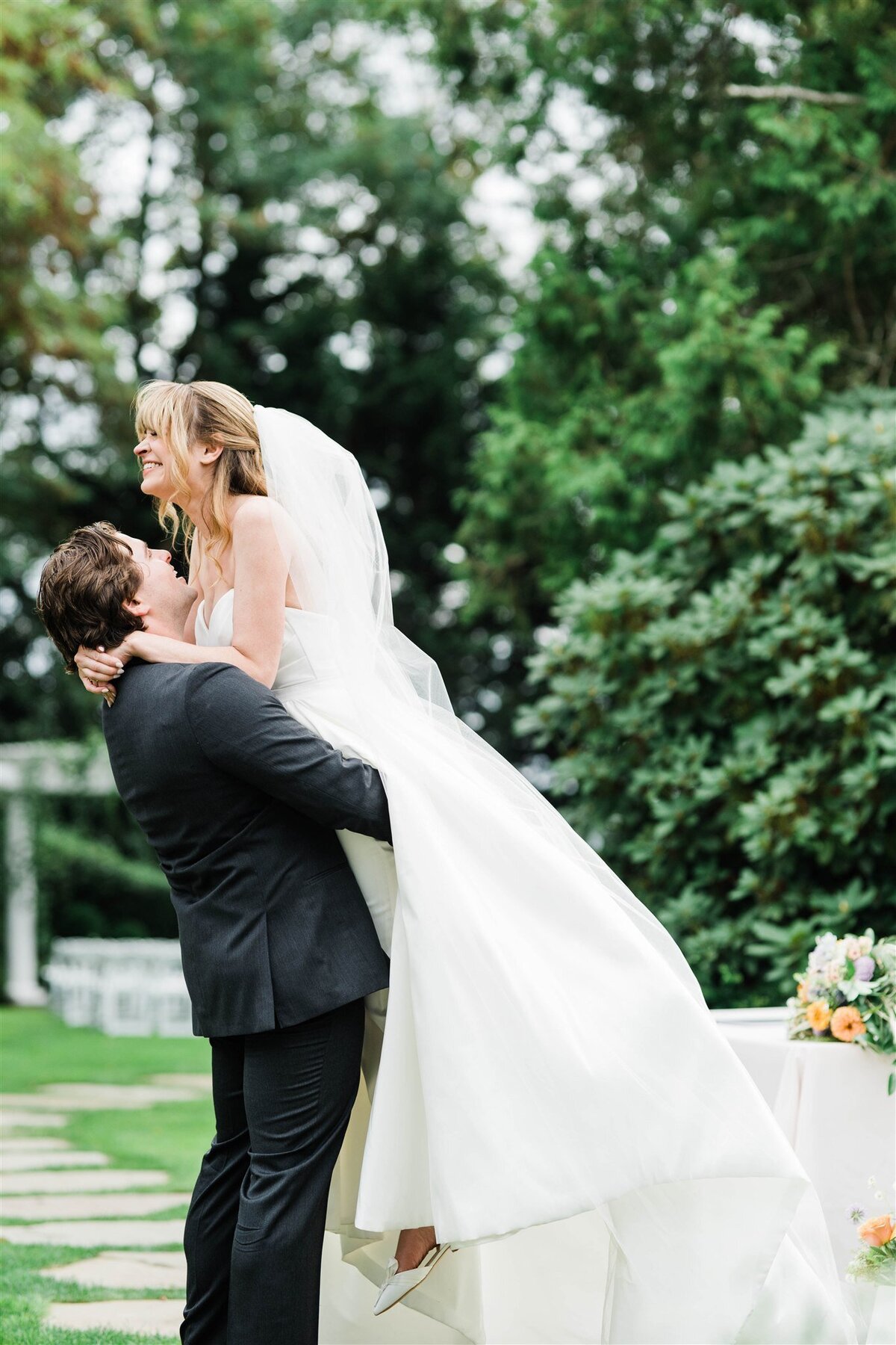 descriptive + SEO-friendly (e.g., “Groom lifting bride joyfully during their outdoor Laurel Creek Manor wedding, captured by Seattle wedding photographer Candace Connor.