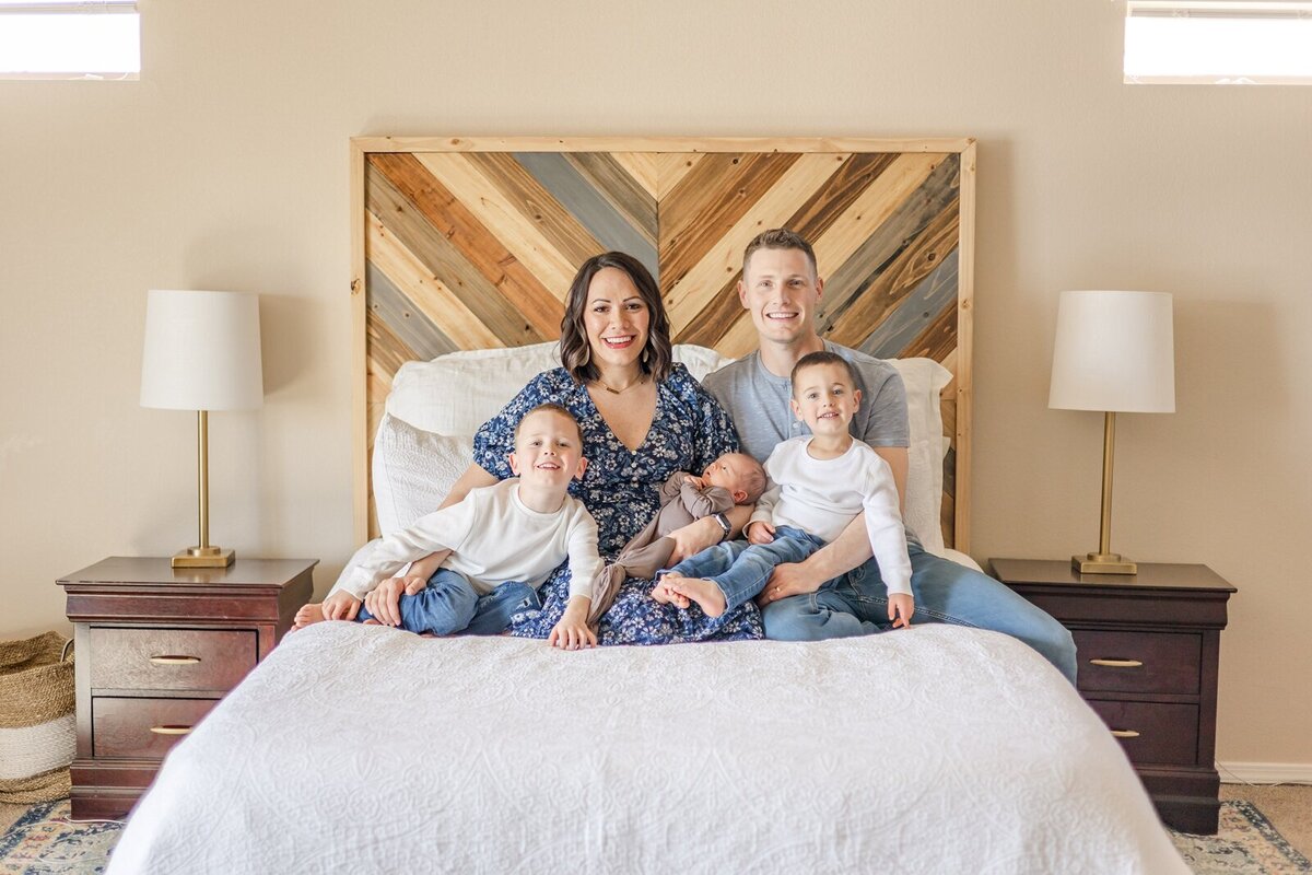 Parents with their three sons at a lifestyle newborn session