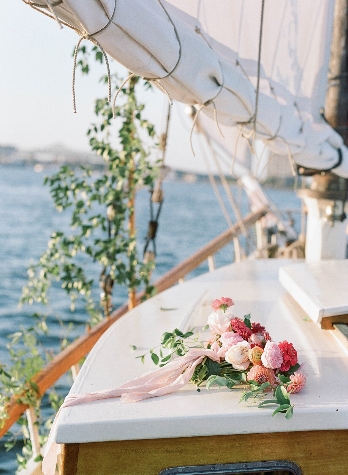 Kate-Murtaugh-Events-elopement-wedding-planner-Boston-Harbor-sailing-sail-boat-yacht-greenery-water-skyline-couple-dahlia-bouquet