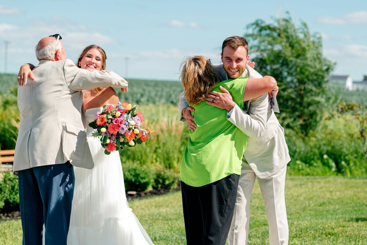 bride-and-groom-hugging-guests