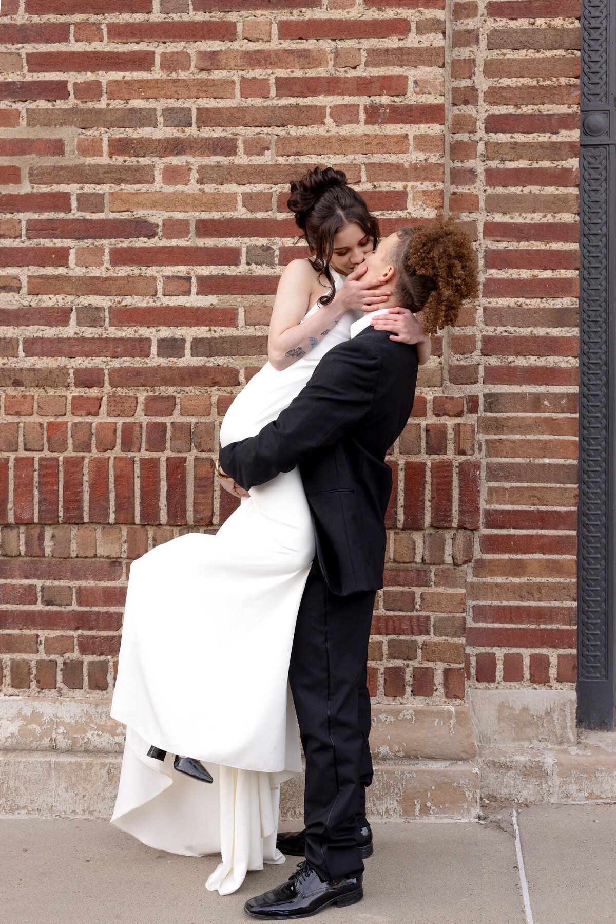 groom lifting bride into a kiss