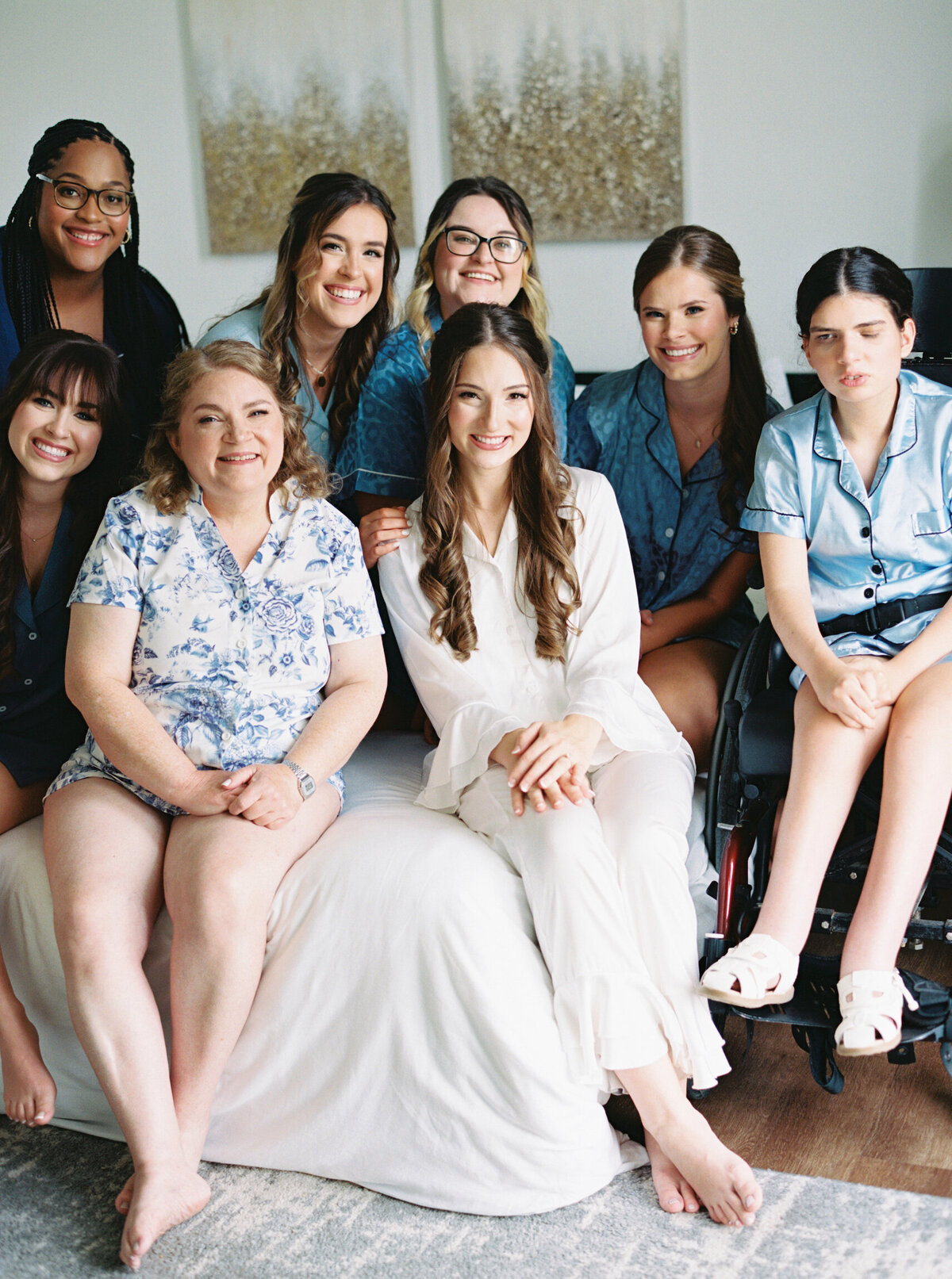 A joyful moment with the bride and her bridesmaids in coordinated blue and white pajamas, capturing pre-wedding excitement and friendship on film by Morgan Alysse, Louisiana film photographer.