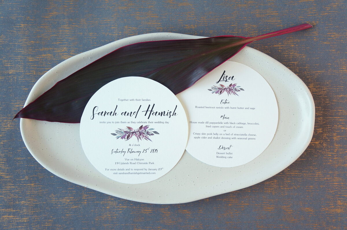 Round wedding invitation and round wedding reception menu and place card, with matching purple and green foliage design