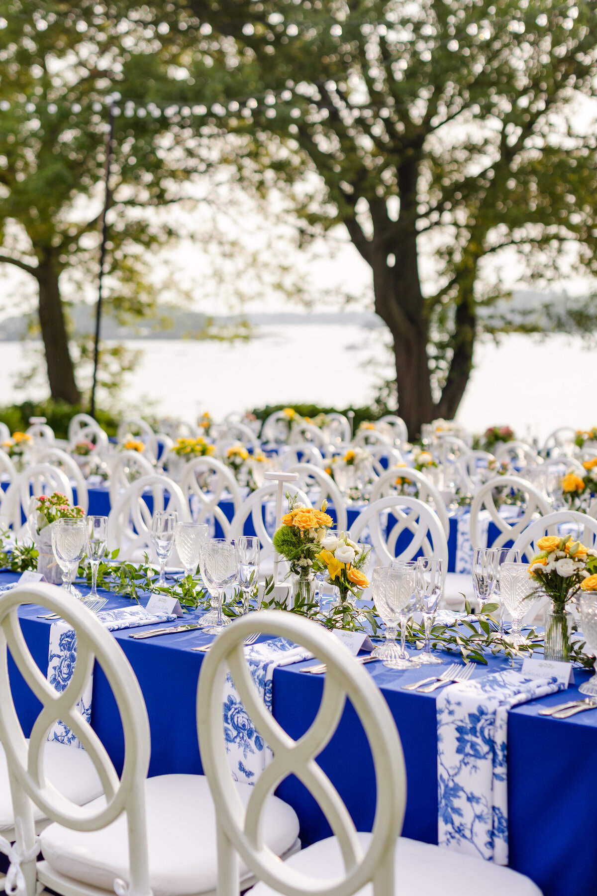 blue and yellow details on the rehearsal dinner table overlooking the water at Wainwright House in Rye