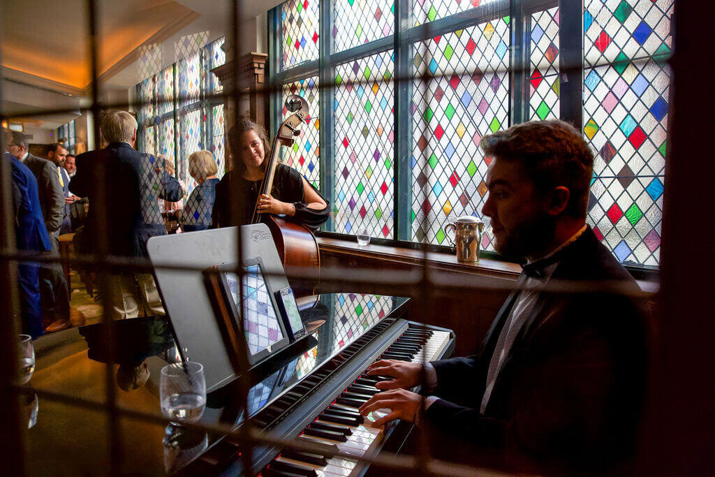 A pianist and Cellist play during a Ivy wedding reception