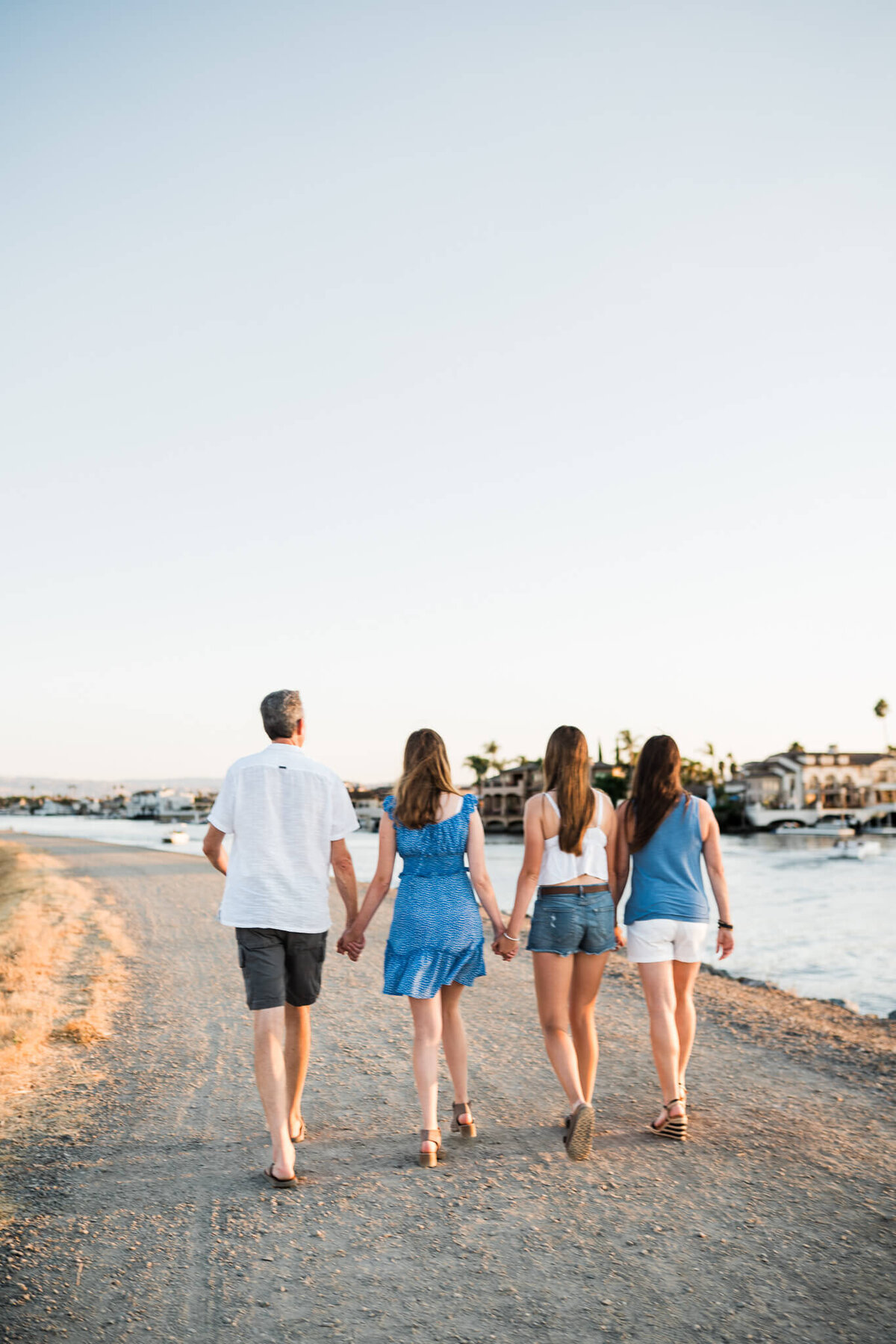 Family walking away on the Lake By Vanessa Montano |Brentwood Family Photographer