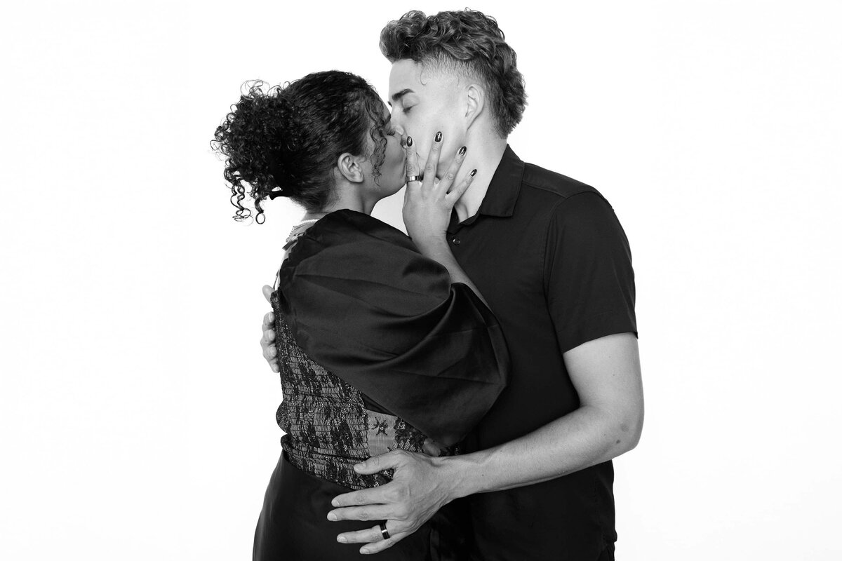 Couple sharing a kiss in a timeless black and white portrait captured by Monochrome Portraits, an elevated Arizona photo booth experience.