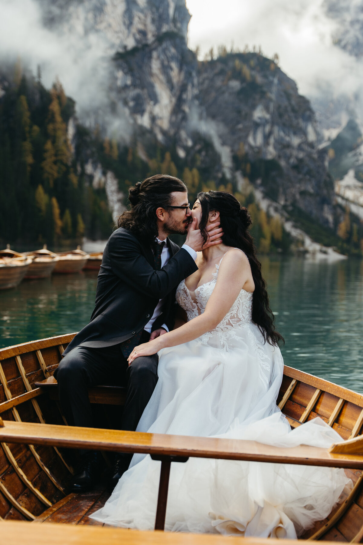 Couple kissing in wooden boat on Lago di Braies