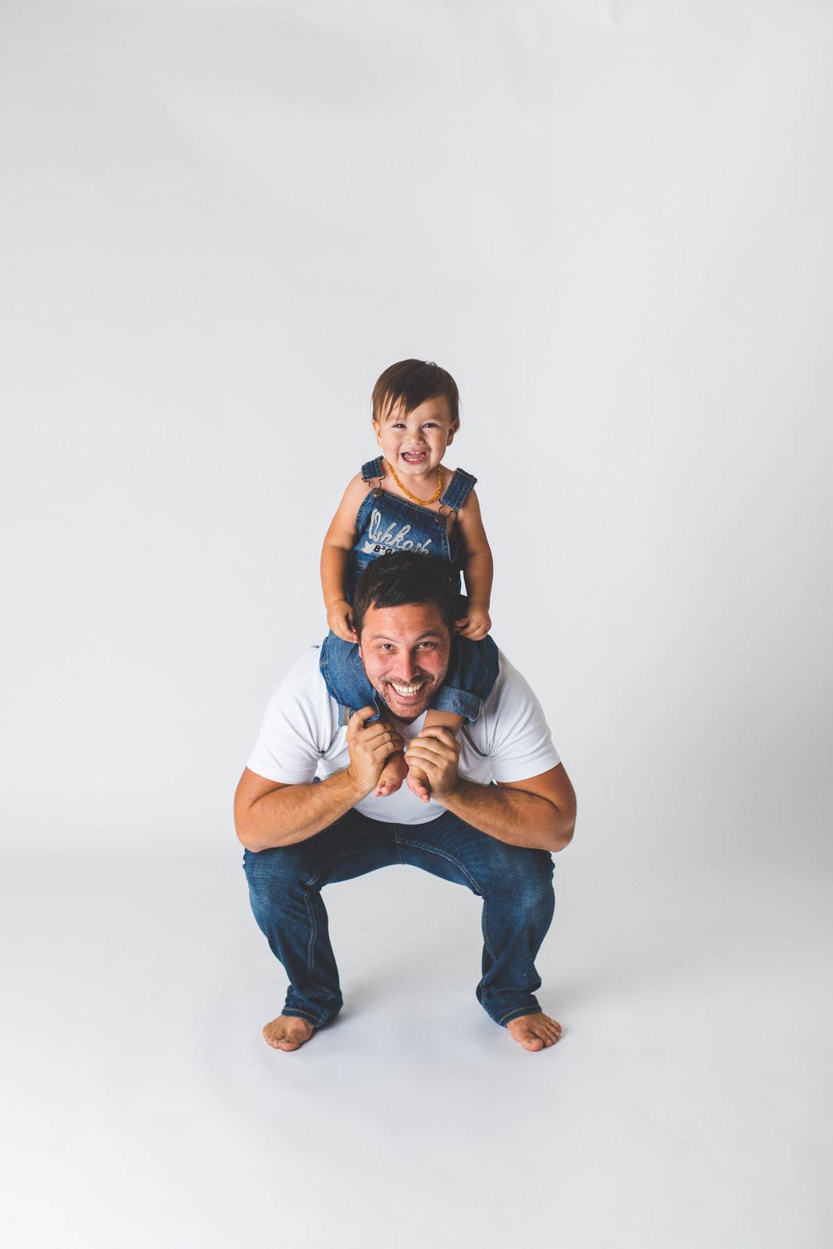 Father and son baby family session in studio on white background