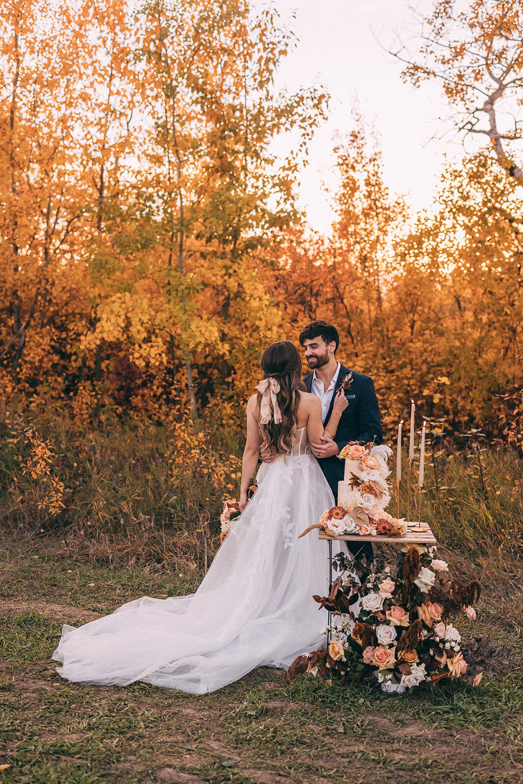 Bride and groom at their Fall wedding at River's Edge, a picturesque country wedding venue in Devon, Alberta, featured on the Brontë Bride Vendor Guide.