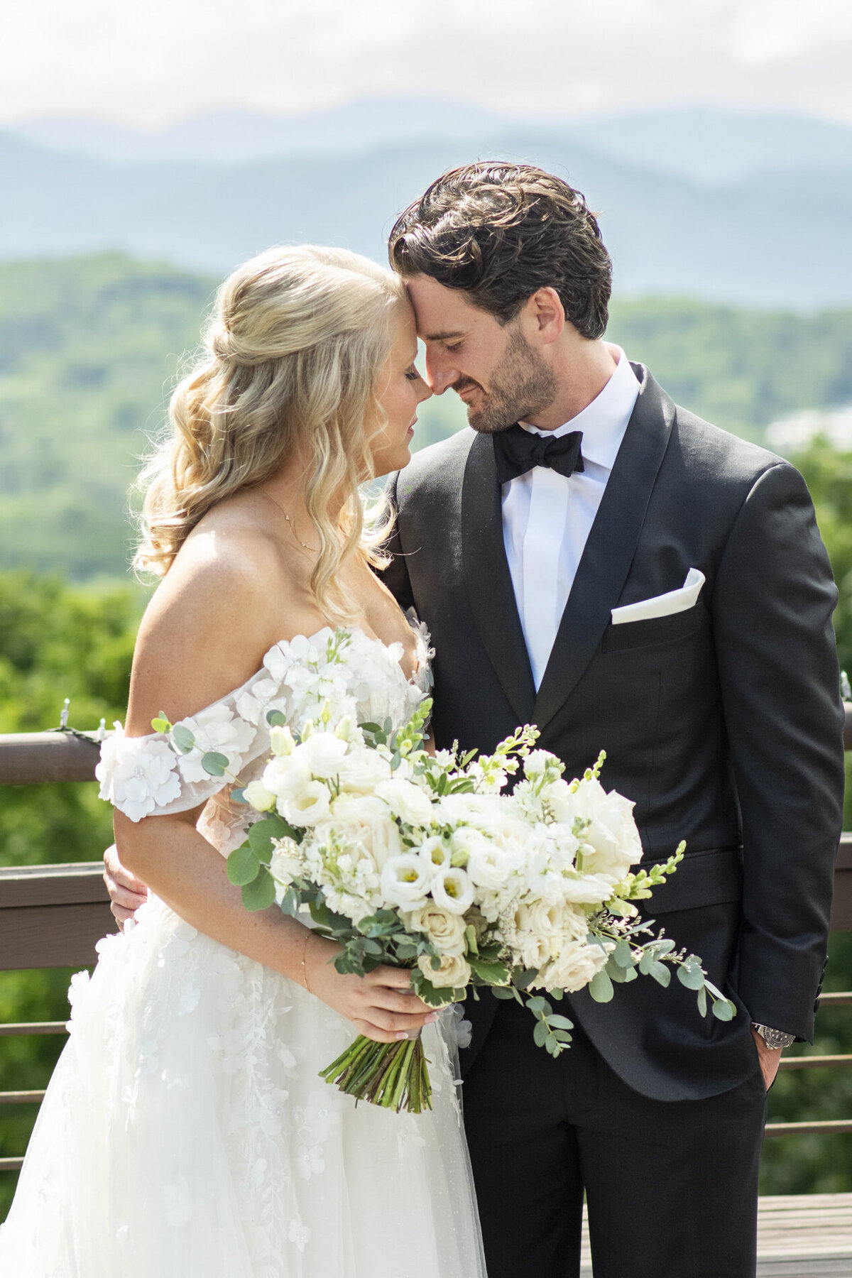 Couple snuggling with mountain view at Crest Pavilion Asheville wedding