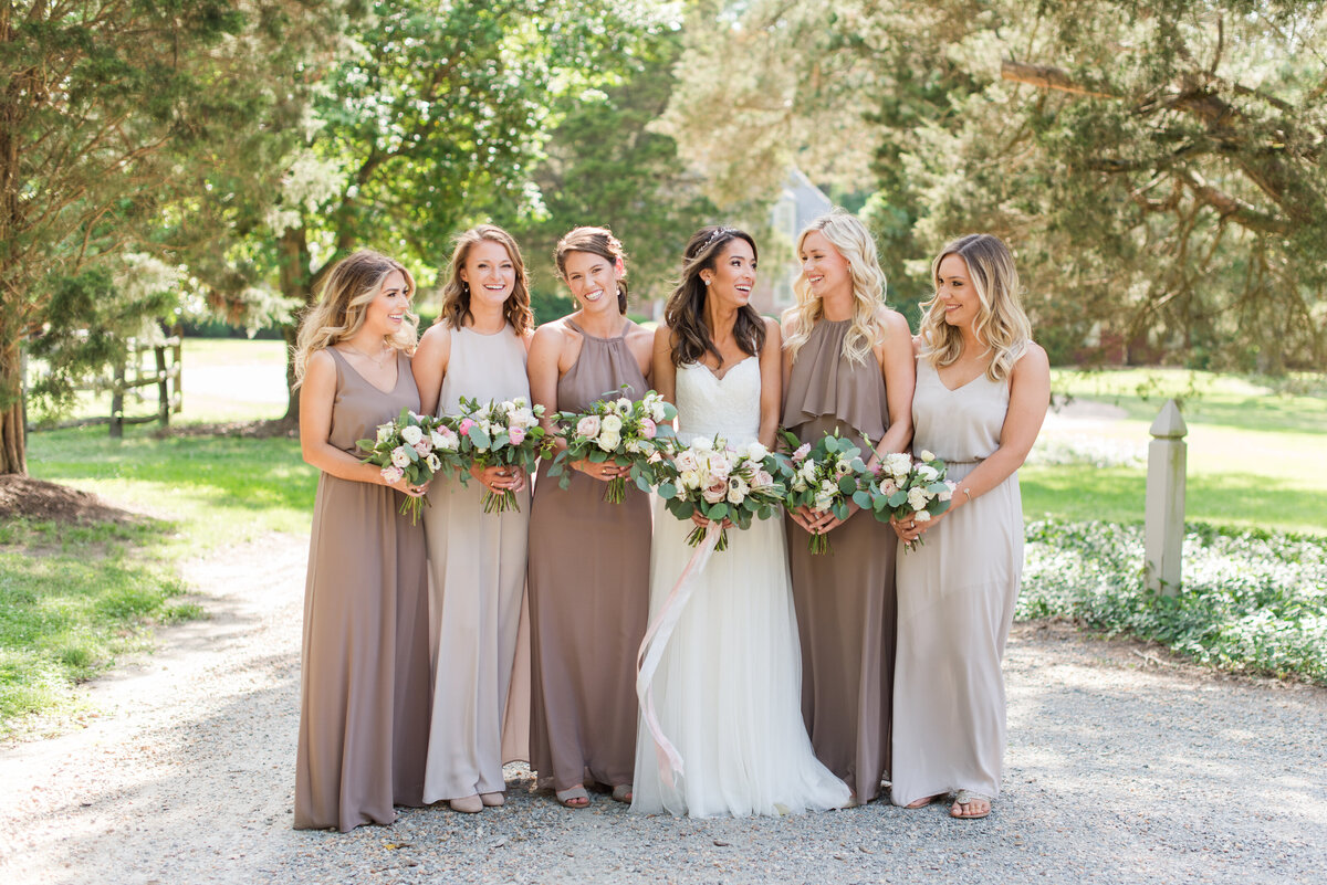 colonial historic venue with bridal party in golden light laughing