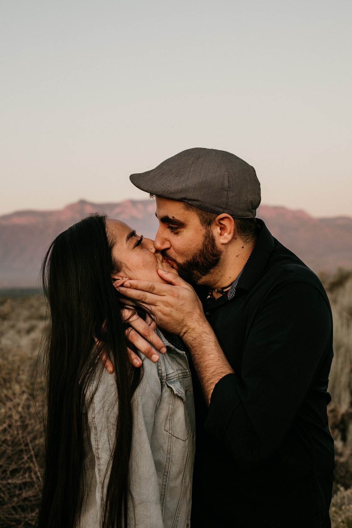 man holding fiancé's face kissing her