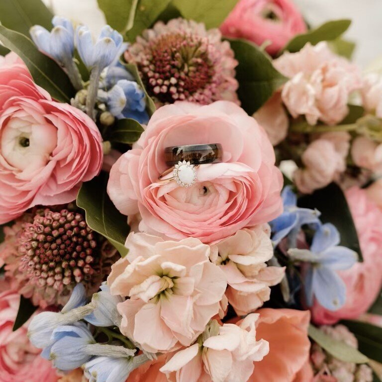 close-up-photo-of-wedding-bouquet-and-engagment-rings