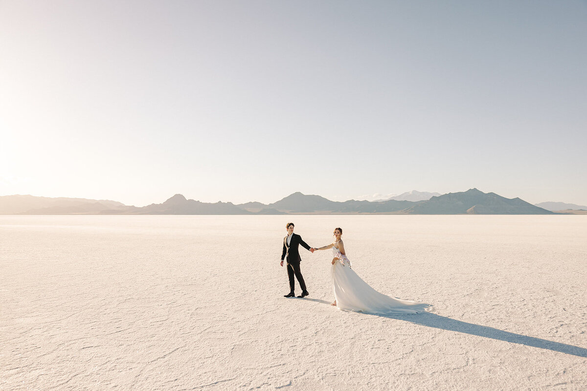 Utah Wedding Photography capturing couple walking through Salt Flats