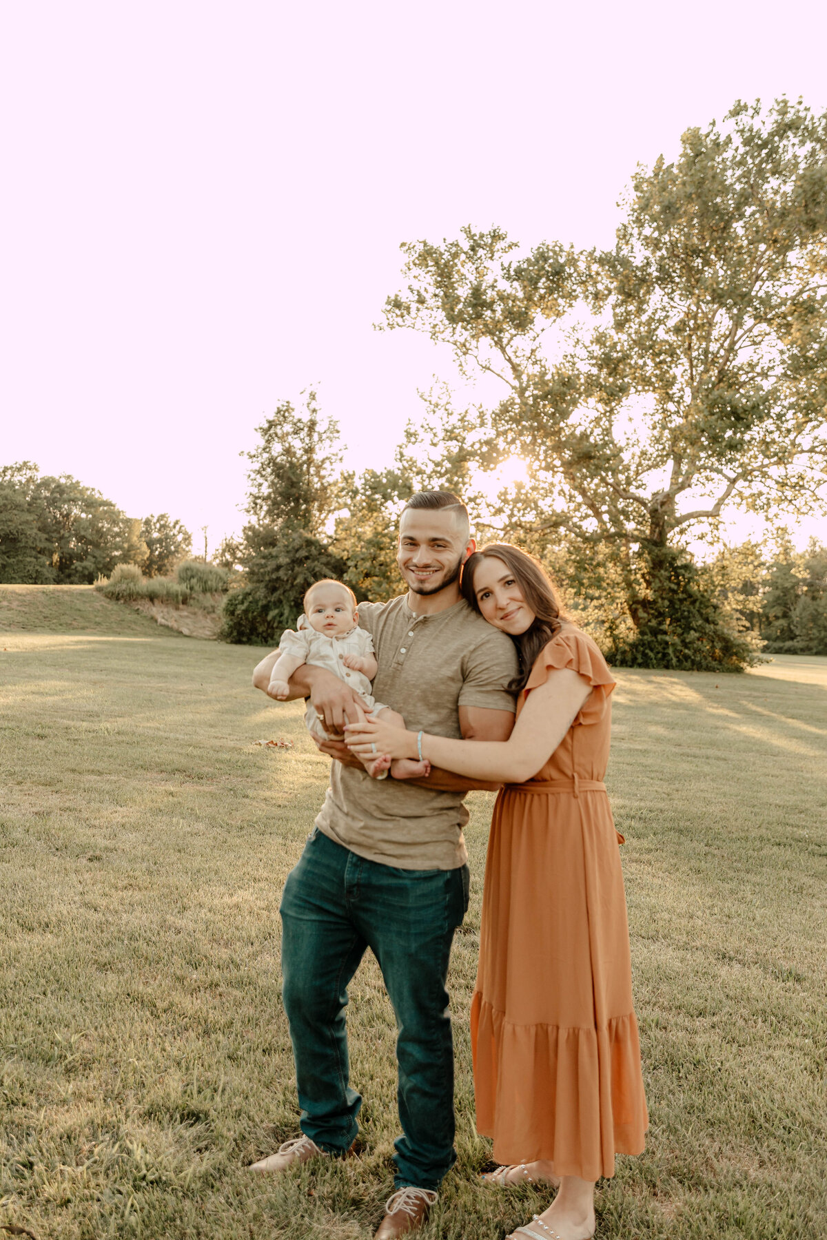 a couple holding a baby during their family session in Union County NJ
