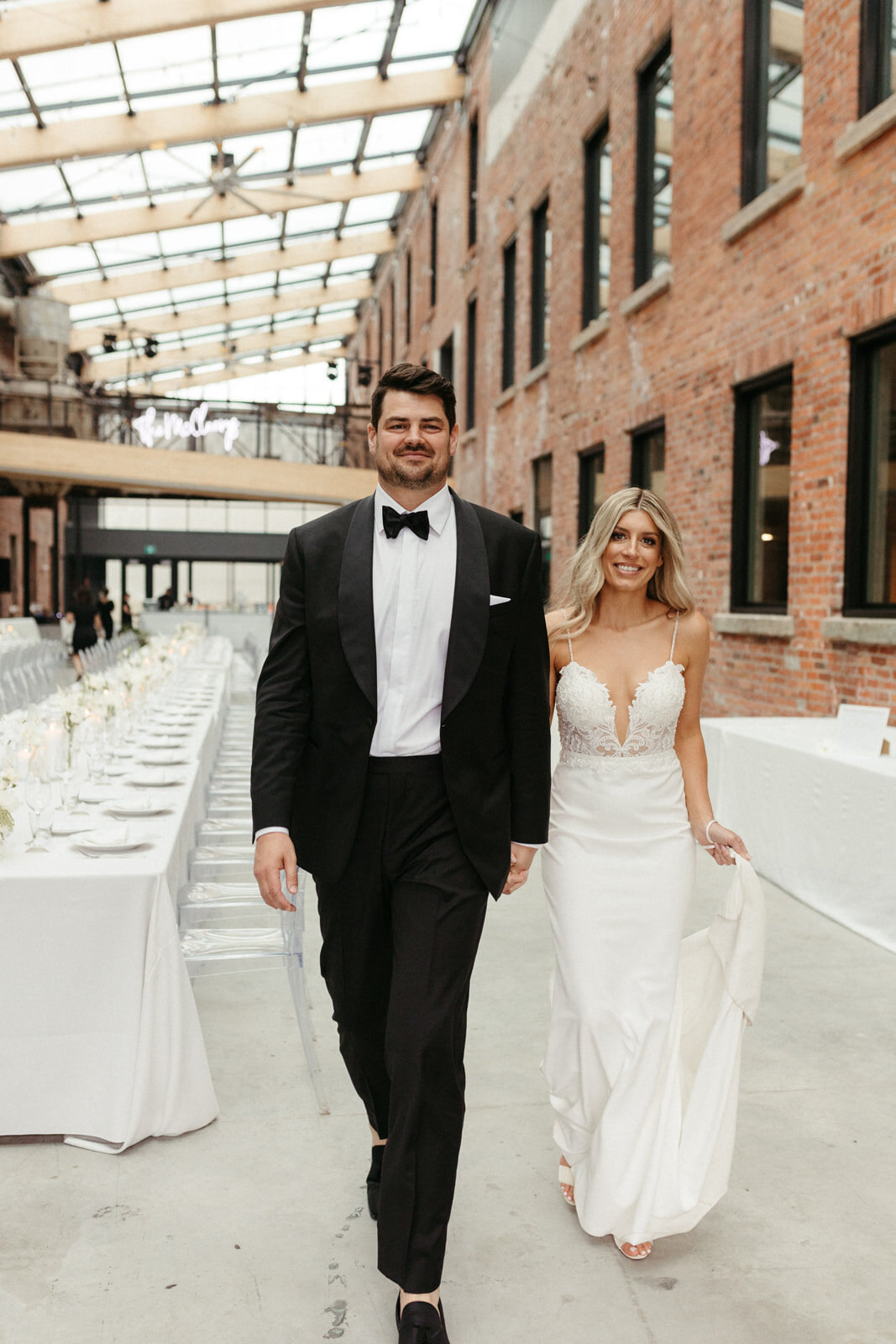 Elegant indoor industrial brick wall wedding party photo