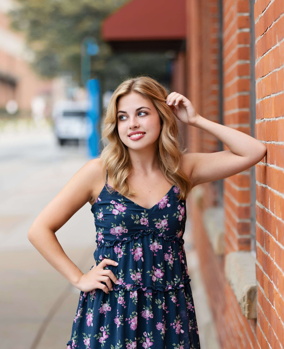 Senior portrait of a girl leaning into a building in downtown Erie Pa