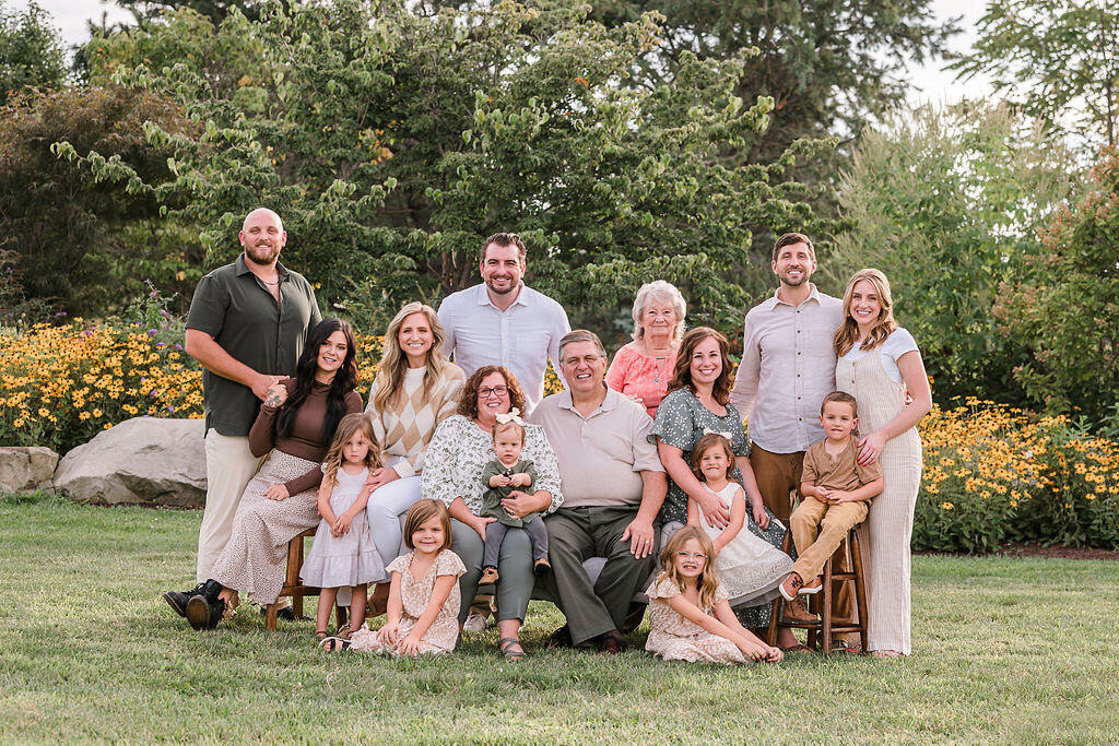 Large extended multi-generational family smile in family portrait