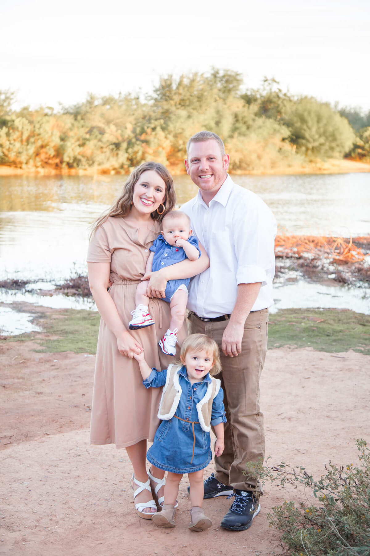 Portrait of a family of four by a pond