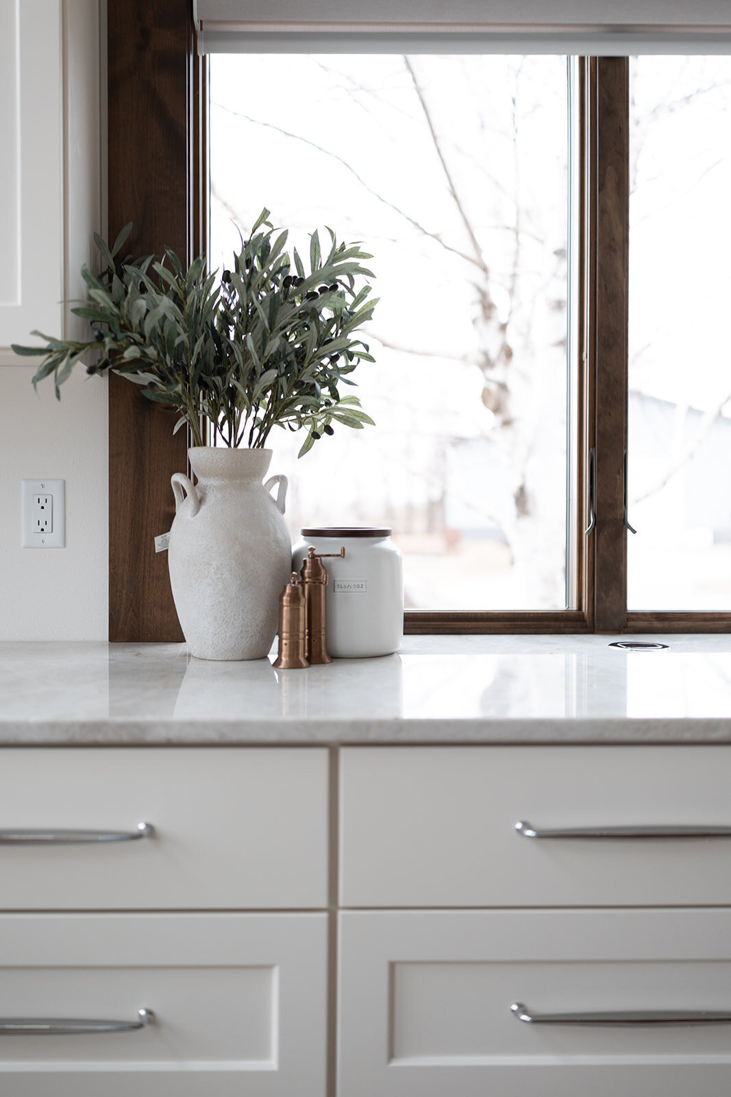 michele rosenboom design clean country renovation kitchen counter with white vase and greenery