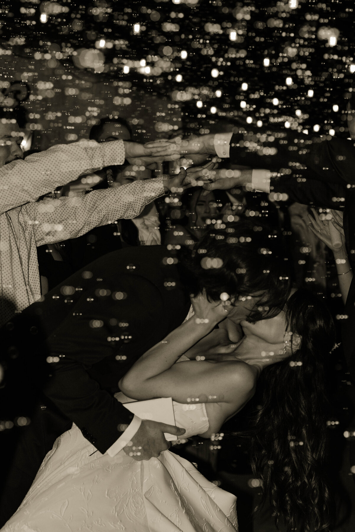 bride and groom wedding exit kiss photo black and white photo