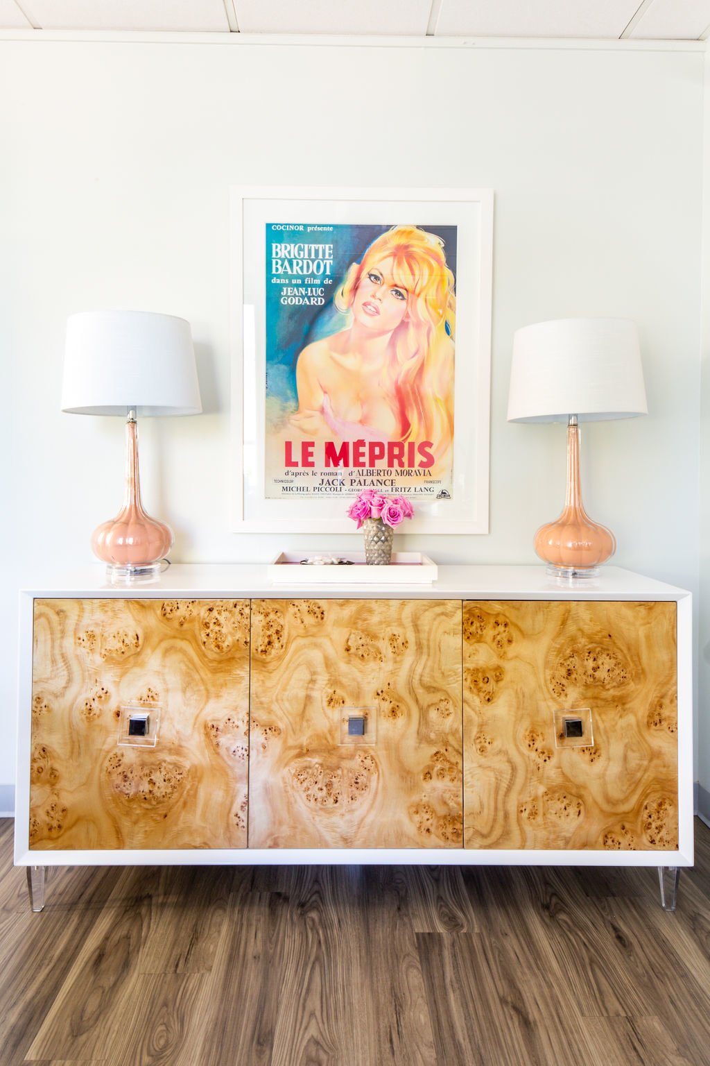 Burled wood credenza with pink lamps