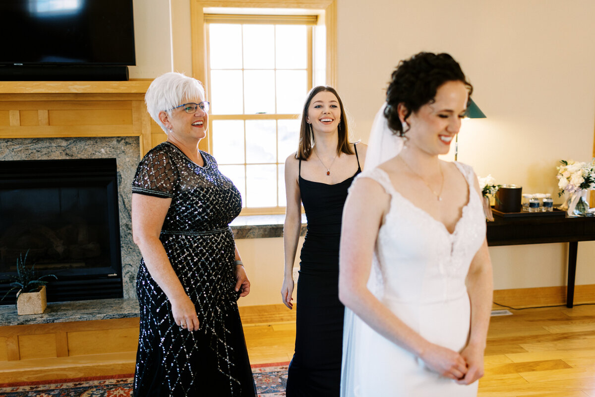 girls helping bride with her veil