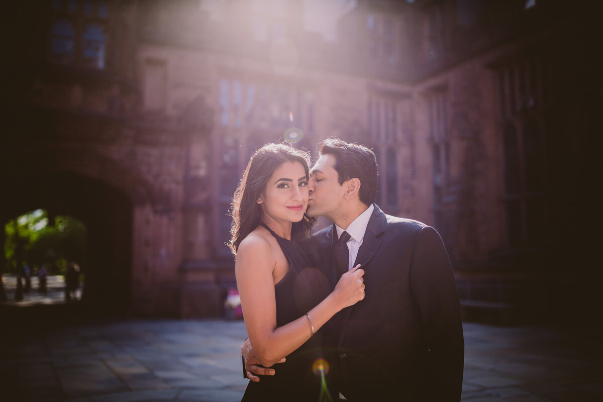 A couple during their engagement session sharing a moment inside the princeton university east pyne hall in nj